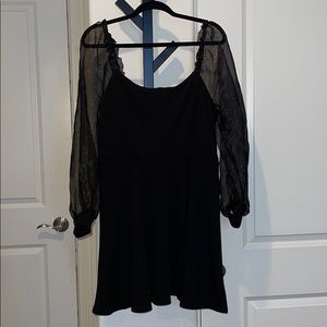 Black dress with sheer sleeves.
